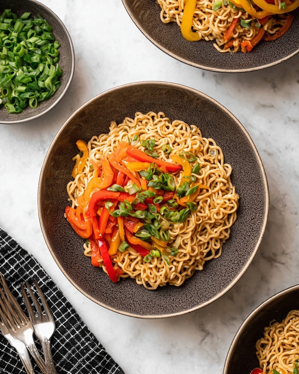 A bowl of cooked noodles sits in the center with three layers visible: the base layer is light brown cooked noodles, the middle layer has bright red and yellow cooked bell pepper strips, and the top layer is sprinkled with fresh green chopped scallions. The bowl is dark gray with a textured rim, placed on a white marbled surface. Around the bowl, parts of two more similar bowls and a separate bowl filled with chopped scallions are visible, along with a folded black and white checkered cloth and two forks near the bottom left. photo taken with an iphone --ar 4:5 --v 7