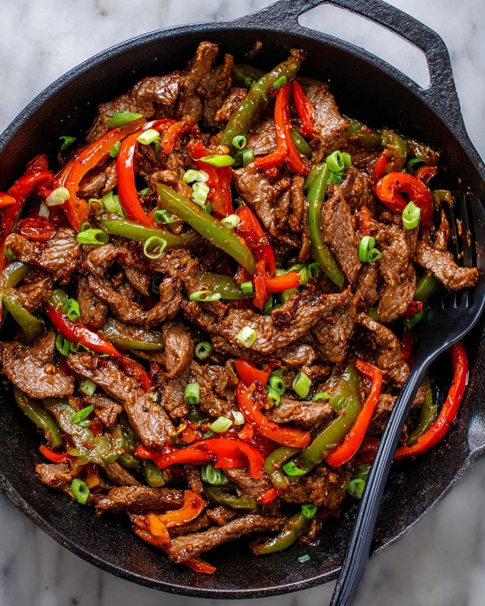 A close-up view of a black cast iron pan filled with cooked beef strips and sliced bell peppers, showing about two main layers: a base layer of tender, browned beef pieces with a shiny, slightly oily texture and a mixed layer of thin red and green bell pepper slices scattered throughout. The beef and peppers are mixed evenly, with a few sprinkled green onion slices adding small bright green accents on top. A black fork is resting inside the pan over the food. The pan is placed on a white marbled surface. photo taken with an iphone --ar 4:5 --v 7