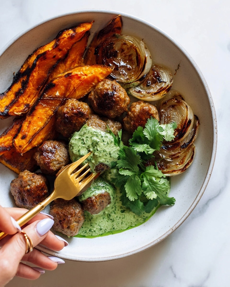 The dish is served in a deep white bowl on a white marbled surface, featuring a base layer of green herb sauce spread thinly over the bottom. On top, there are several browned meatballs with a slightly crispy texture grouping together near the back. Beside the meatballs, a layer of thin, roasted orange sweet potato slices is arranged, some topped with caramelized onion strips that add a shiny, slightly crispy texture. A sprig of fresh green herbs rests near the meatballs for garnish. A gold fork is placed diagonally across the bowl, its tines piercing one meatball. Photo taken with an iphone --ar 4:5 --v 7