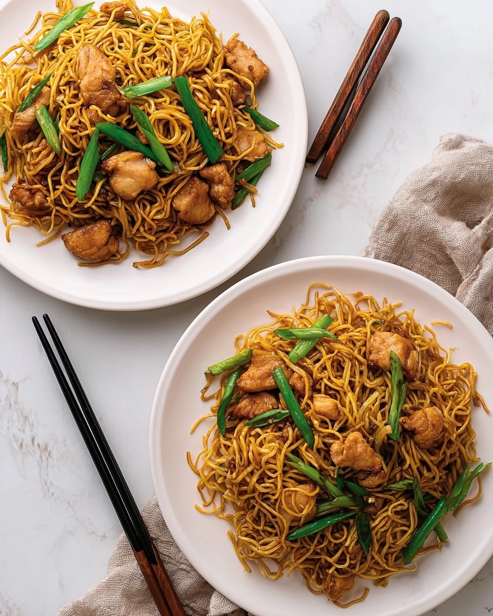 A white plate holds a serving of stir-fried noodles that are a golden brown color, with a slightly glossy texture showing they are well-coated in sauce. Mixed in are several pieces of cooked chicken, slightly browned, and green vegetables that appear to be scallions, adding a fresh contrast to the noodles. A pair of black chopsticks held by a woman's hand lifts a tangle of the noodles above the plate, showing their thin, curly texture and the way they catch the light. The background is a clean white marbled texture, making the food the main focus. photo taken with an iphone --ar 4:5 --v 7