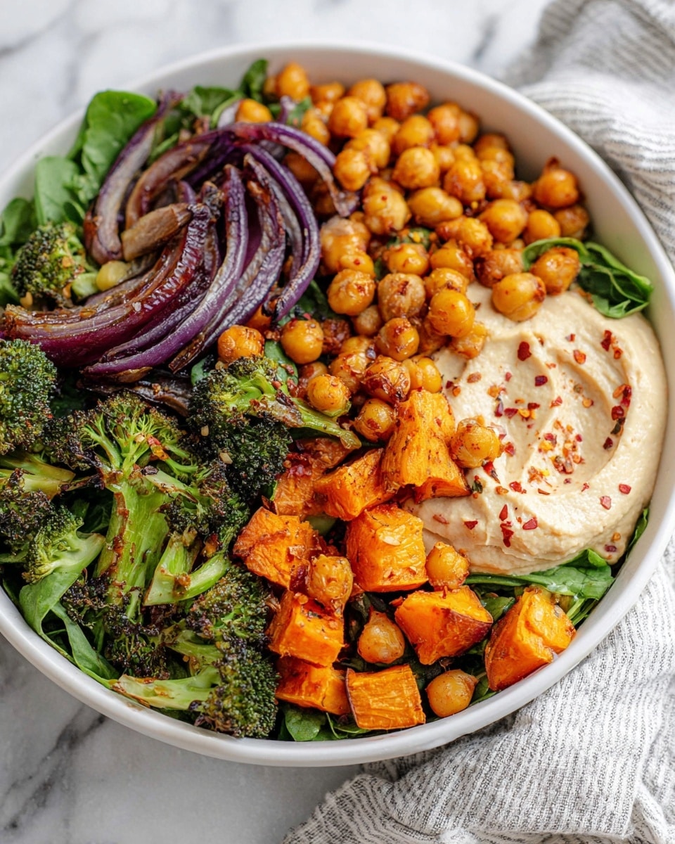 A white bowl filled with a layered mix of roasted chickpeas and orange sweet potato cubes, tender green broccoli florets, and leafy mixed greens, with bits of grilled purple onion scattered throughout. On one side, there is a creamy beige hummus dollop topped with red chili flakes, and on the other side, a serving of fluffy white rice completes the dish. The colors are vibrant and fresh, with roasted textures and leafy greens making the bowl look hearty and healthy, all set on a white marbled surface. photo taken with an iphone --ar 4:5 --v 7