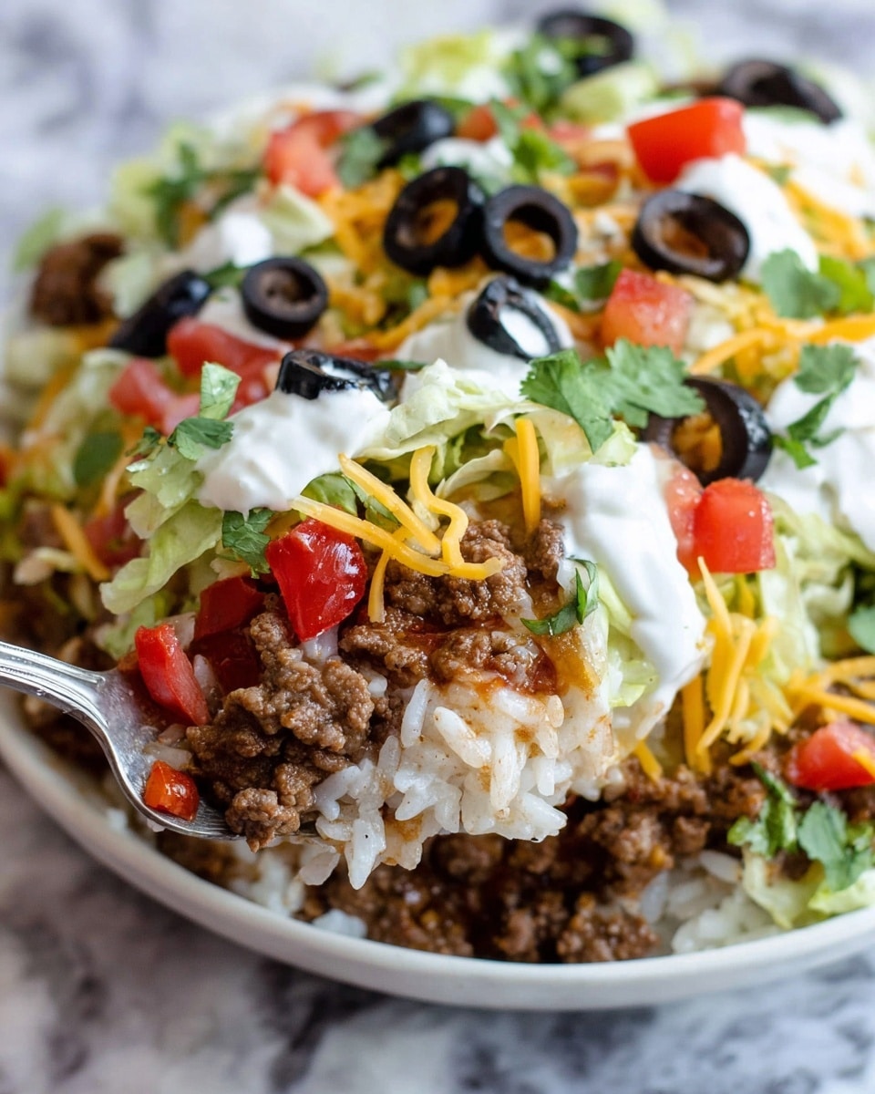 This dish is served in a white bowl and shows several layers with one slice removed. The bottom layer is a cooked ground meat mix with rice, showing a brown and soft texture. Above it is a thick white creamy layer, likely sour cream or cheese sauce, spread unevenly. The top layer is colorful with chopped fresh tomato pieces in red, sliced black olives, shredded white and yellow cheese, green sliced jalapeños, chopped pale green lettuce, and bright green cilantro leaves scattered across. The bowl sits on a white marbled surface. photo taken with an iphone --ar 4:5 --v 7