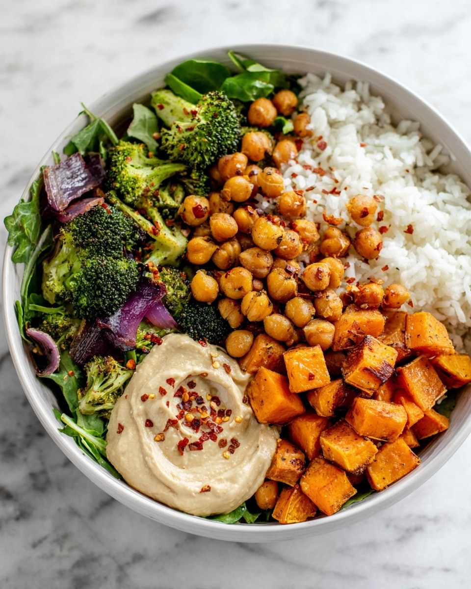 A white bowl filled with a colorful salad layered with fresh green leafy vegetables at the base, topped with golden roasted chickpeas and orange roasted sweet potato cubes scattered all over. Bright green roasted broccoli florets are placed on top, along with thin slices of charred purple onion. On one side of the bowl, there is a creamy light beige hummus dollop sprinkled with red chili flakes. The bowl sits on a white marbled texture surface with a soft striped cloth nearby. photo taken with an iphone --ar 4:5 --v 7